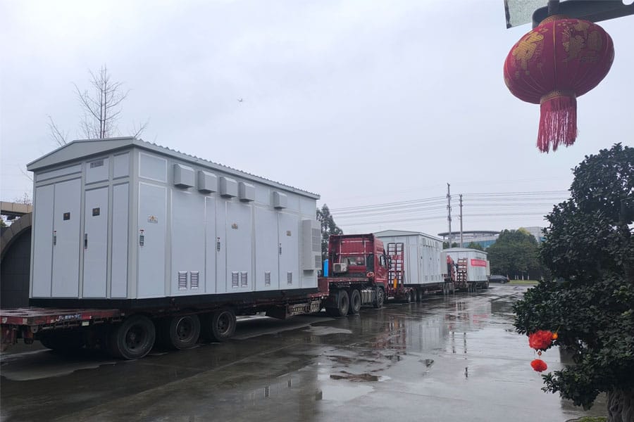 Three large prefabricated modular substations 3.7x3.5x7.5m lined up at Zhongxin General factory gate ready for dispatch