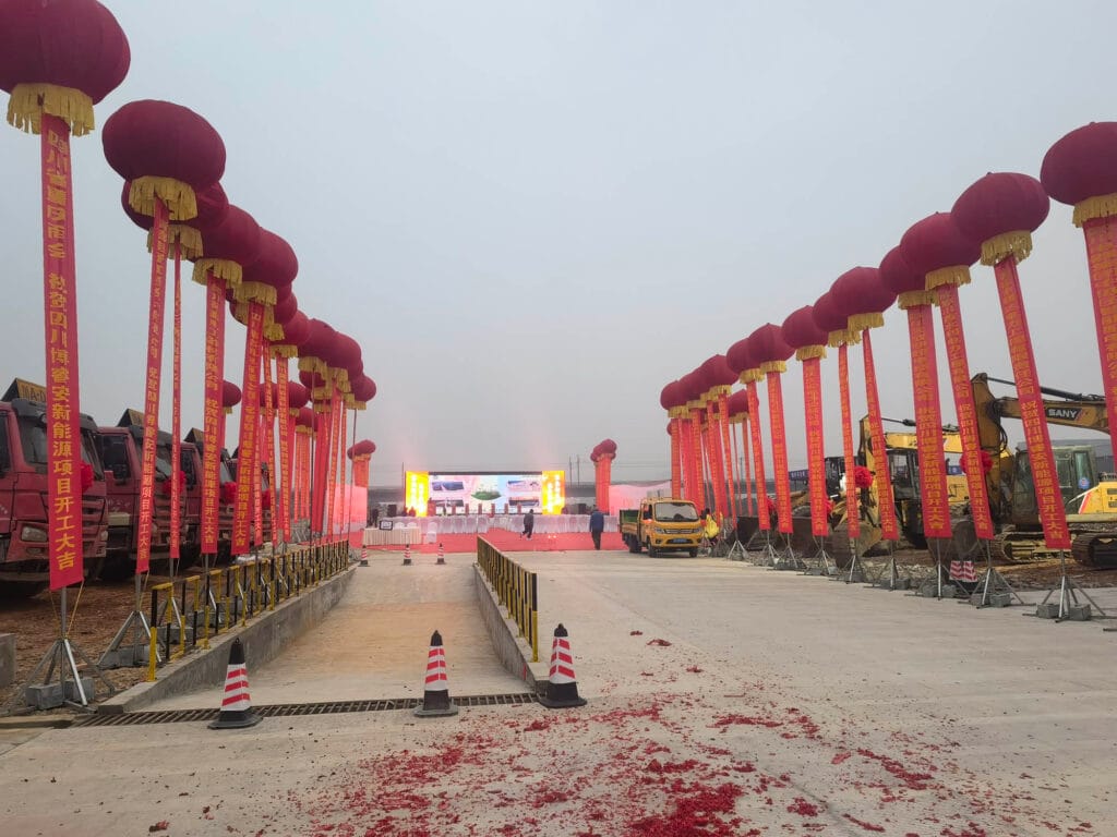 Complete by 8:08 AMBoruian groundbreaking ceremony venue fully prepared with seating, stage, and decorations in Xinjin by 8:08 AM