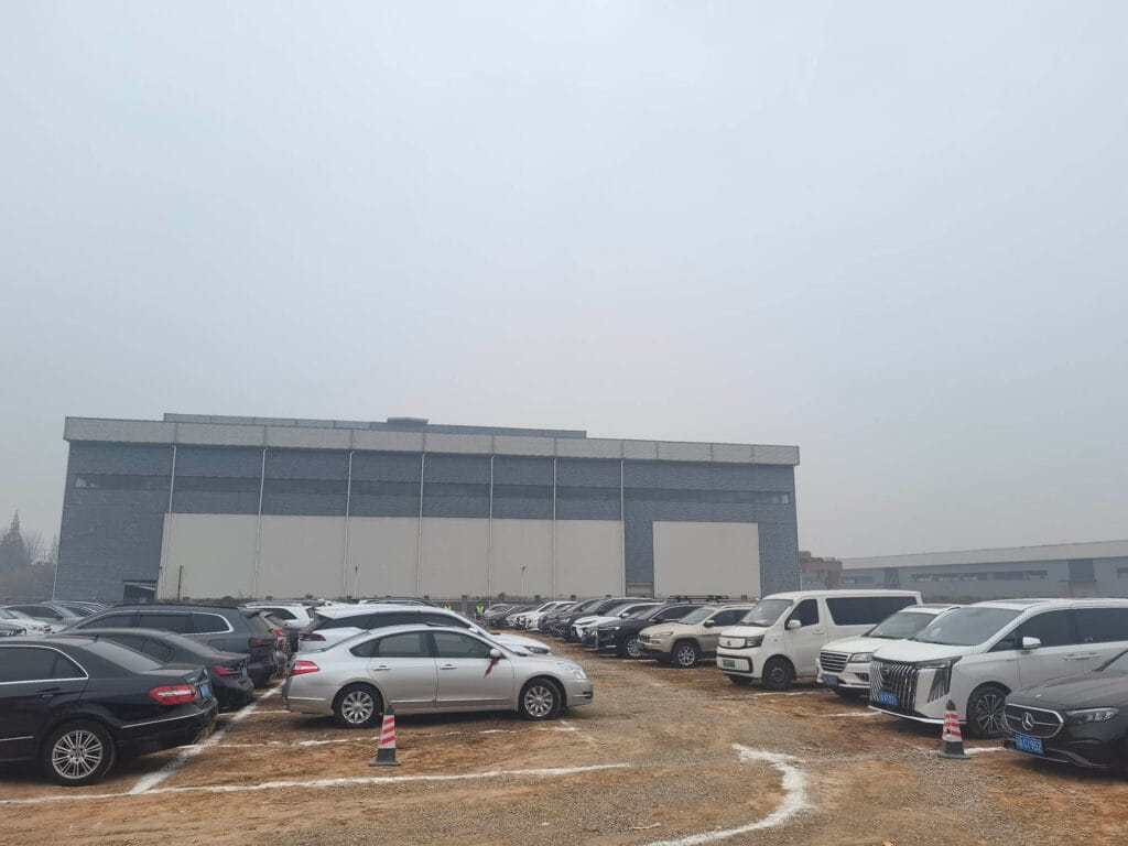 Another view of fully occupied parking area at Boruian New Energy groundbreaking ceremony in Xinjin