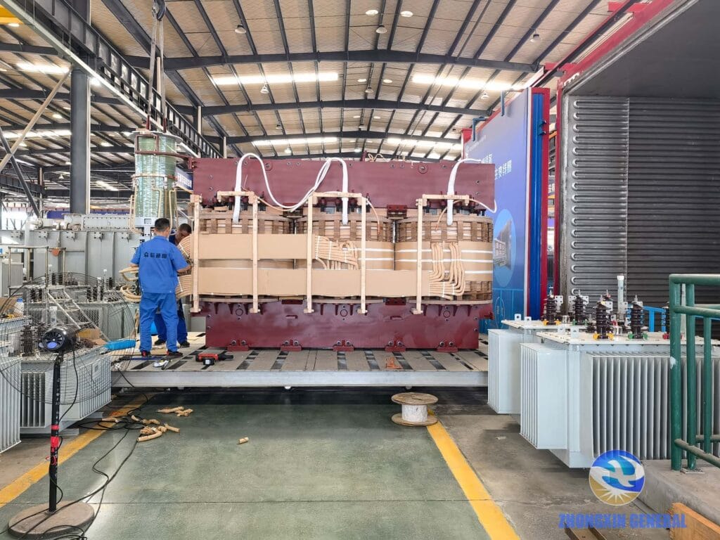 Technicians conducting on-load tap changer functionality testing on 63000kVA transformer before vacuum drying at ZX TRANSFORMER factory