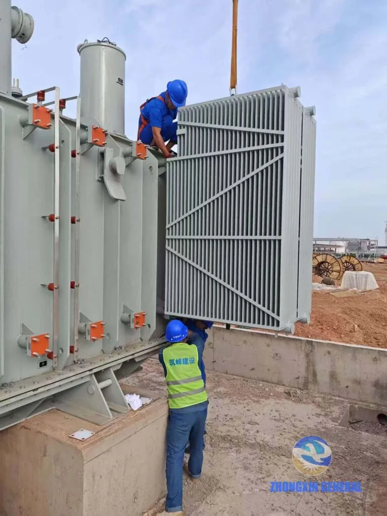 Installation crew assembling ONAN cooling radiators on 63MVA oil-immersed transformer at Gaoshawo Industrial Zone Ningxia