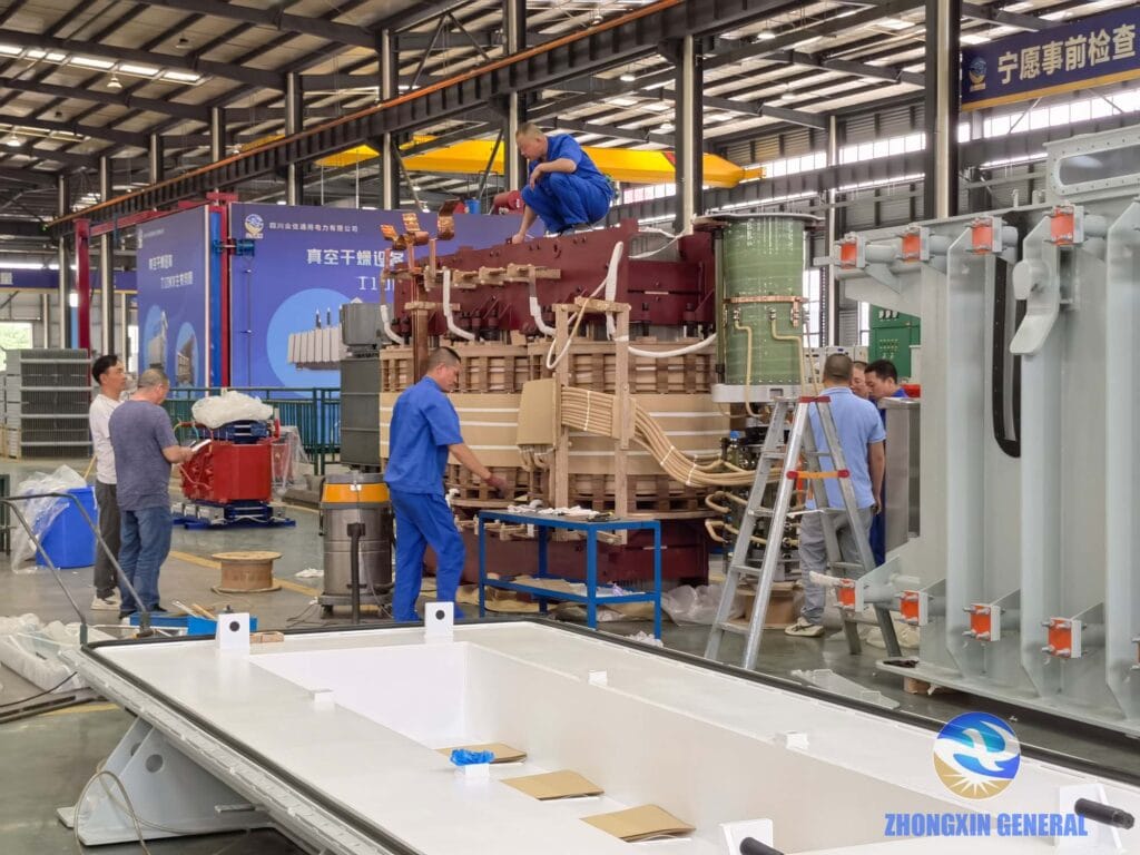 Engineering team conducting final quality inspection of 63MVA transformer active part before lowering into oil tank at Zhongxin General facility