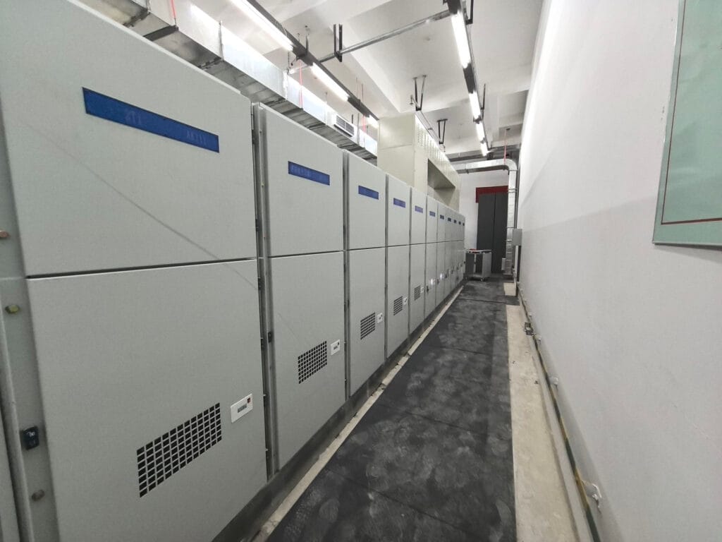 Rear view of switchgear installation showing cable management and safety infrastructure at Xinjin Hospital
