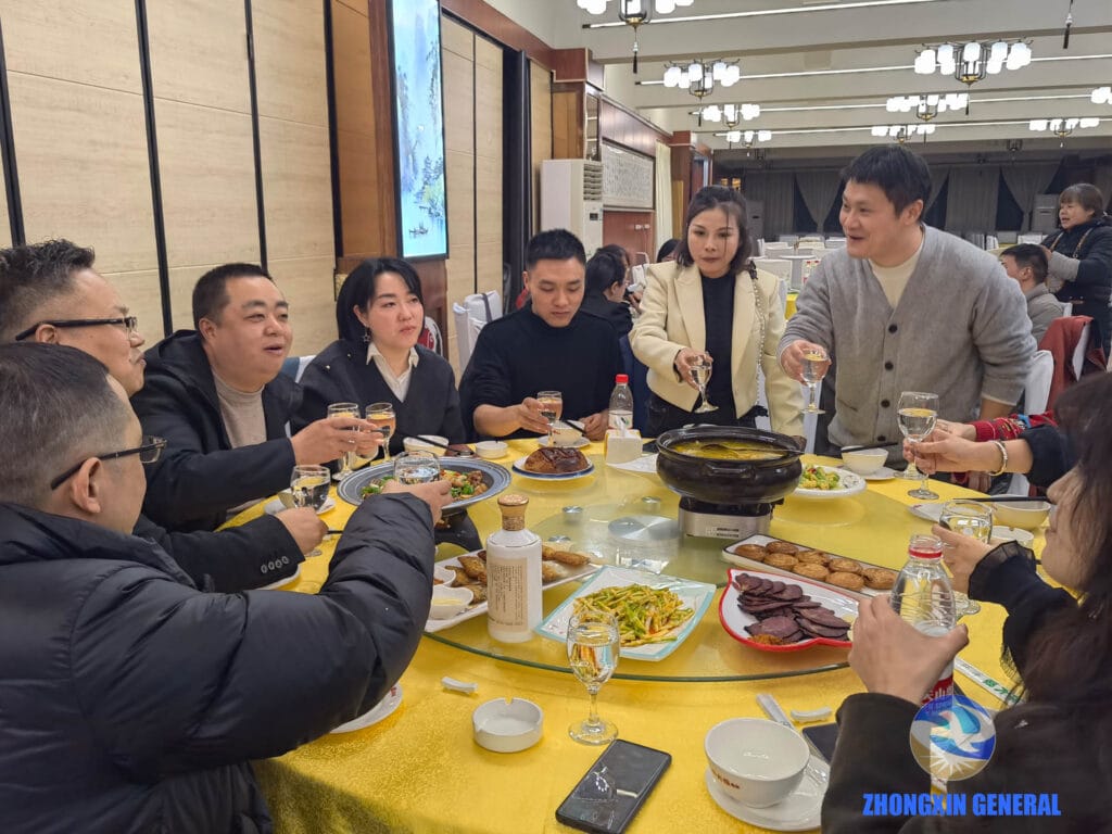 Sales team members raising glasses in toast at annual banquet celebration