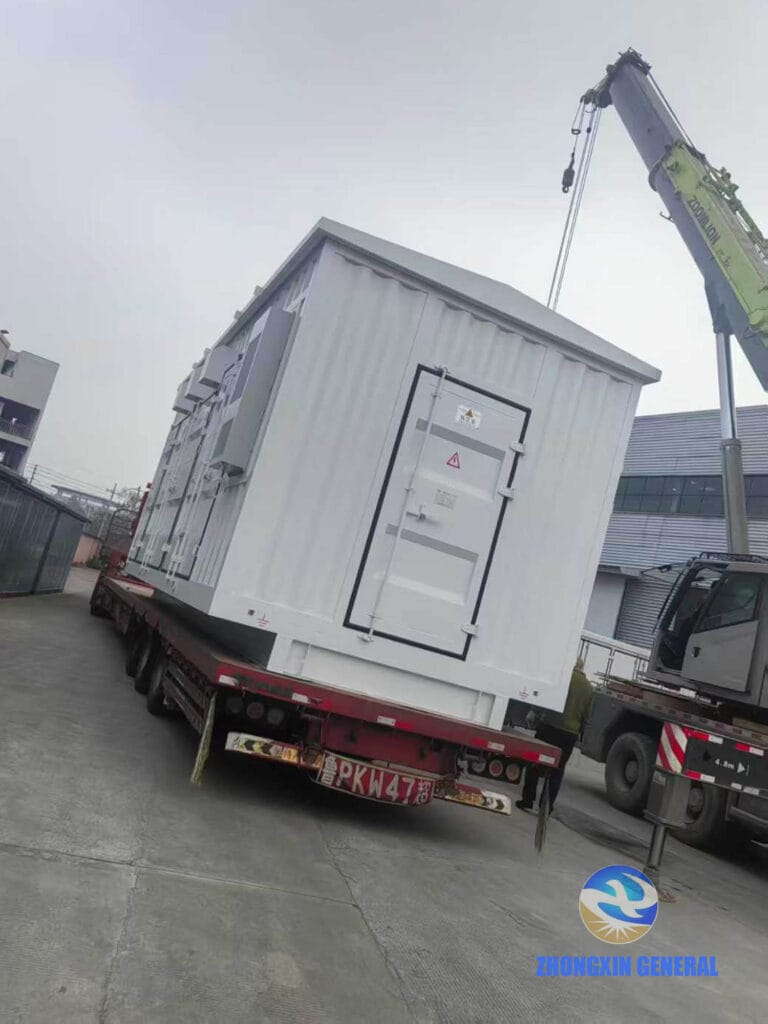Crane lifting prefabricated containerized substation for truck loading