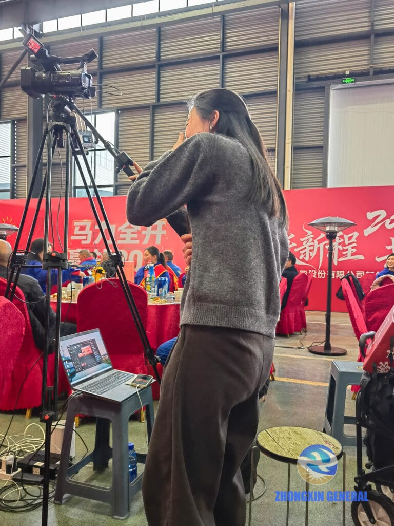 Livestream operator laughing enthusiastically during team performance at annual gala celebration