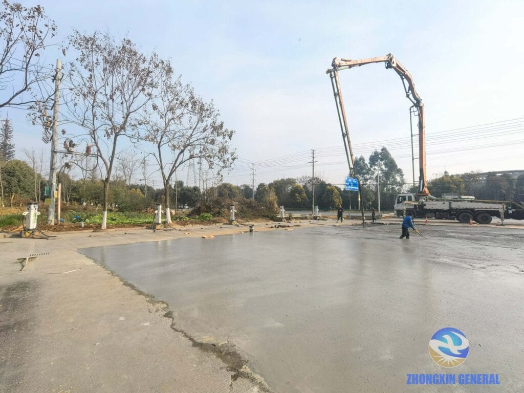 View from inside charging station showing pumper truck and nearly completed concrete surface renovation