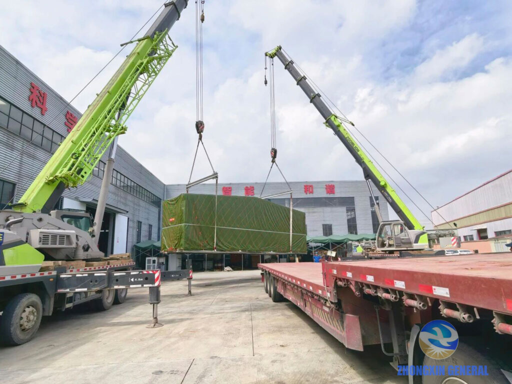 Two outdoor cranes working in tandem to lift prefabricated substation transport module for truck loading — Zhongxin General Chengdu Kazakhstan dispatch