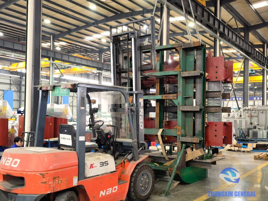 Forklift and overhead crane coordinating to erect 31500 kVA transformer core — ZHONGXIN GENERAL manufacturing