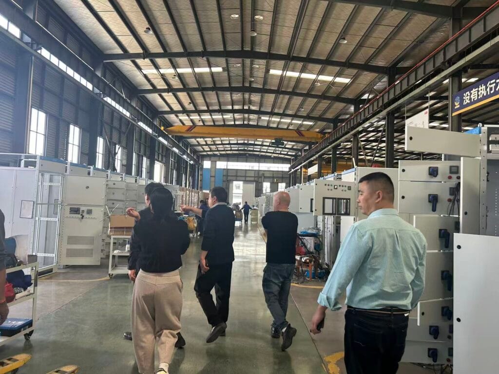 Guizhou Bijie phosphate-coal chemical project delegation inspecting medium and low voltage switchgear production workshop at Zhongxin General Electric