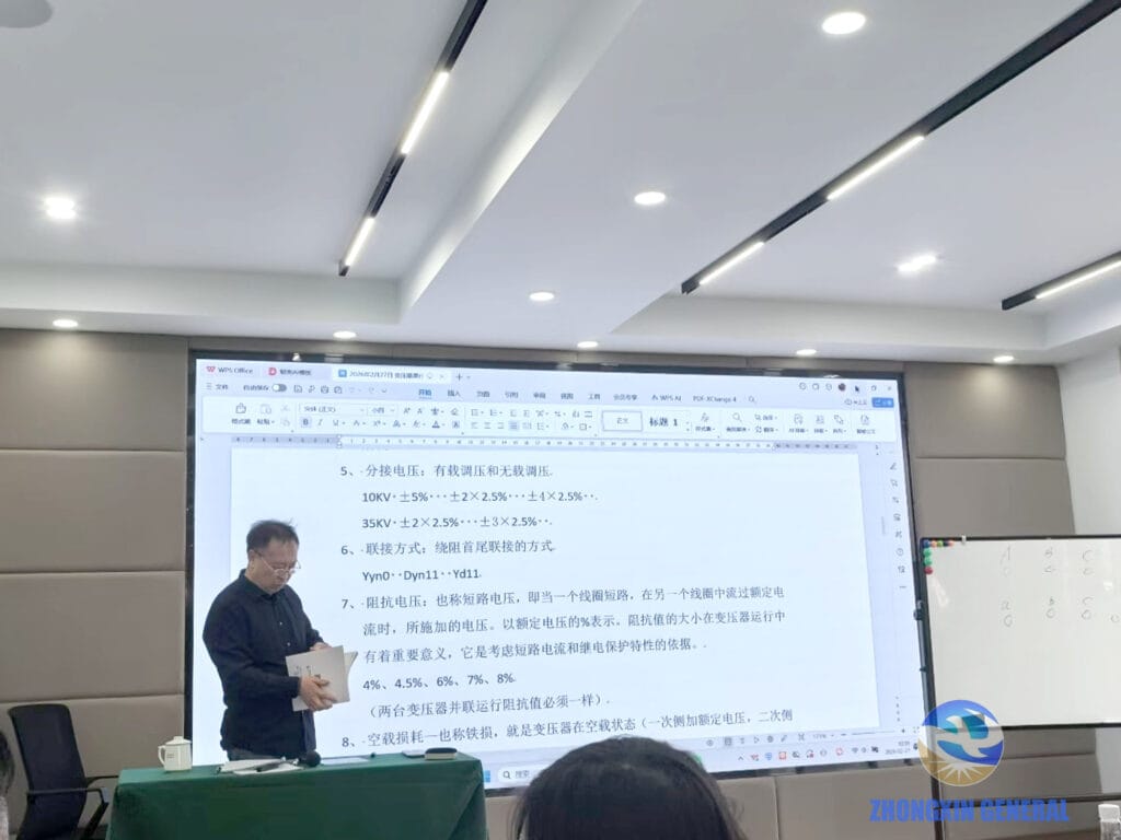 Li Xianming, co-founder and Transformer Technical Advisor of Zhongxin General, presenting transformer knowledge covering tap voltage, winding connection methods, and impedance voltage, with detailed technical notes displayed on the classroom screen.