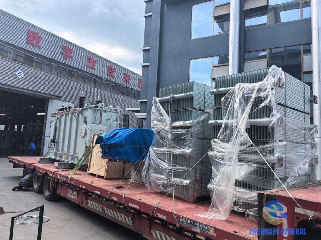 16,000 kVA 35kV OLTC transformer loaded on heavy transport truck — view from factory gate toward workshop, Zhongxin General April 2026