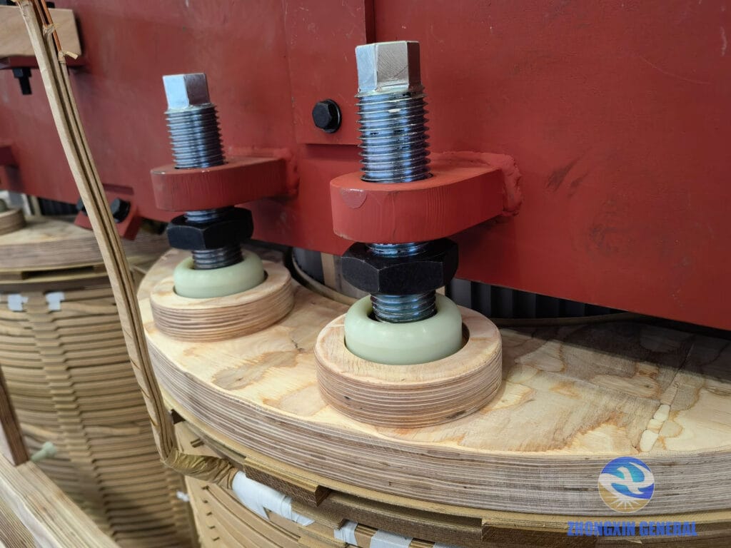 Winding assembly secured to core clamping frame — 16,000 kVA 35kV OLTC transformer active part assembly, Zhongxin General