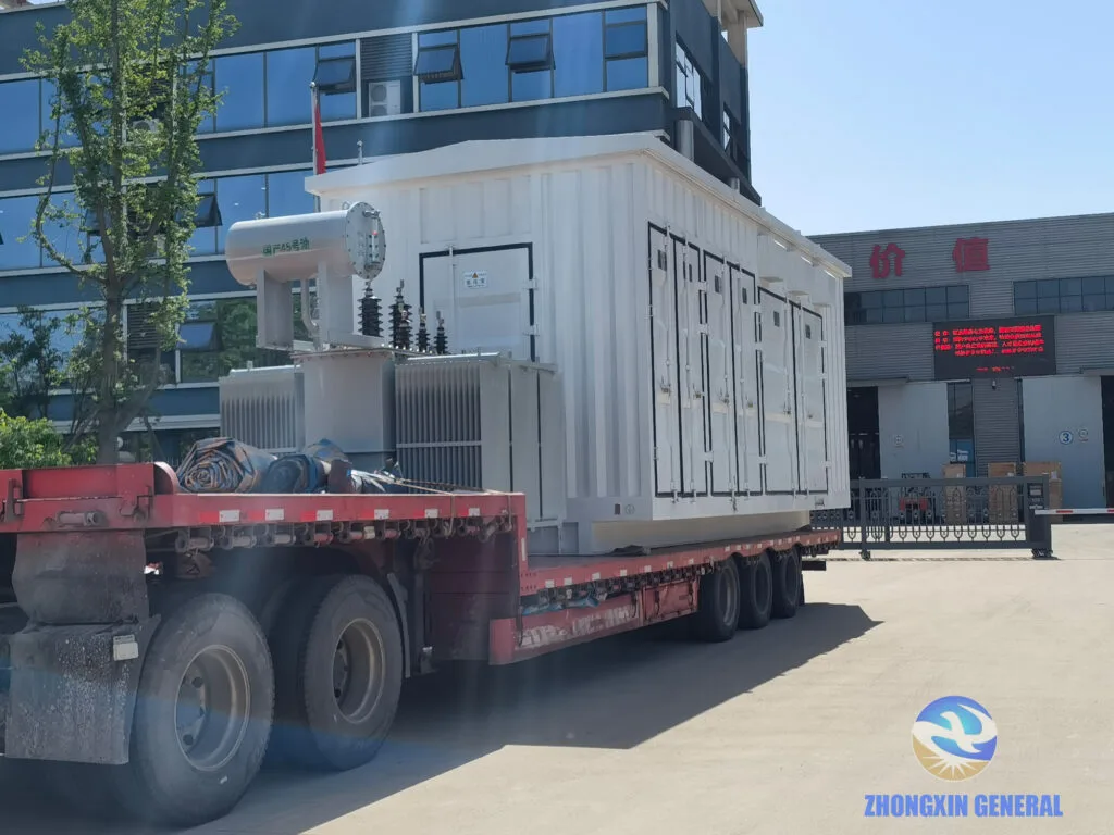 First prefabricated box substation loaded on truck at Zhongxin General factory gate — PetroChina Luntai Tarim oilfield Xinjiang April 2026