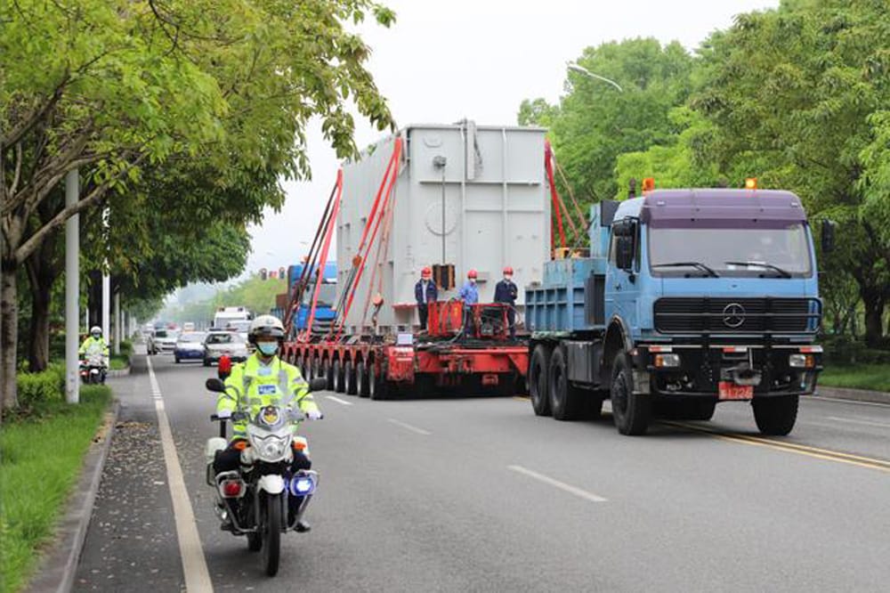 Heavy transport convoy carrying 500 kV spare main transformer on road to Three Gorges power station with police escort, 2020