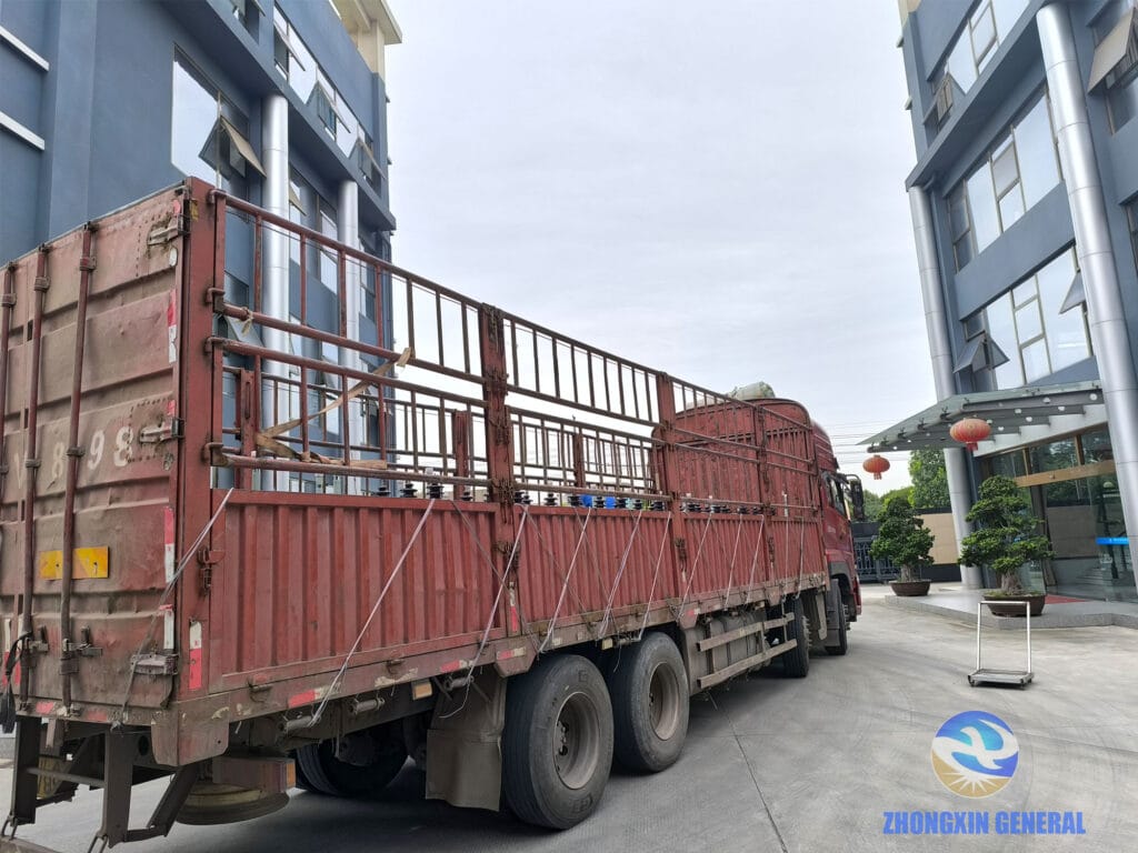 Batch of 100 kVA oil-immersed distribution transformers loaded on truck ready for domestic dispatch — Zhongxin General