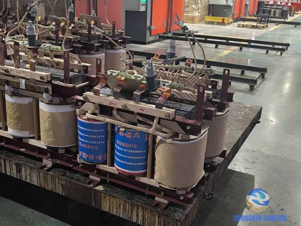 Batch of 100 kVA oil-immersed transformer active parts entering high-temperature drying oven — Zhongxin General