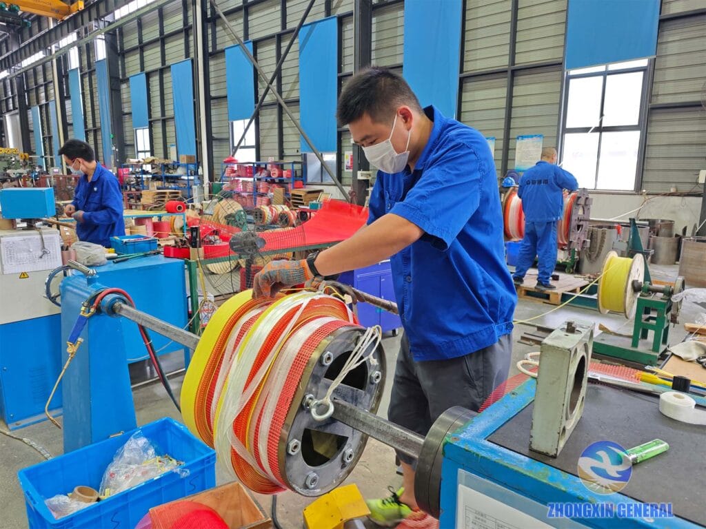 Skilled technician winding the high-voltage coil of a 250 kVA cast resin dry-type transformer — Zhongxin General Sichuan factory