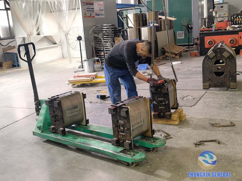 Technician performing demoulding of 30 kVA dry-type transformer epoxy cast winding coil — Zhongxin General production