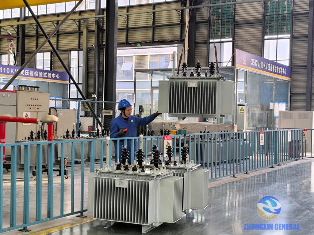 Technician lifting a 400 kVA oil-immersed transformer in preparation for factory acceptance testing — Zhongxin General Sichuan