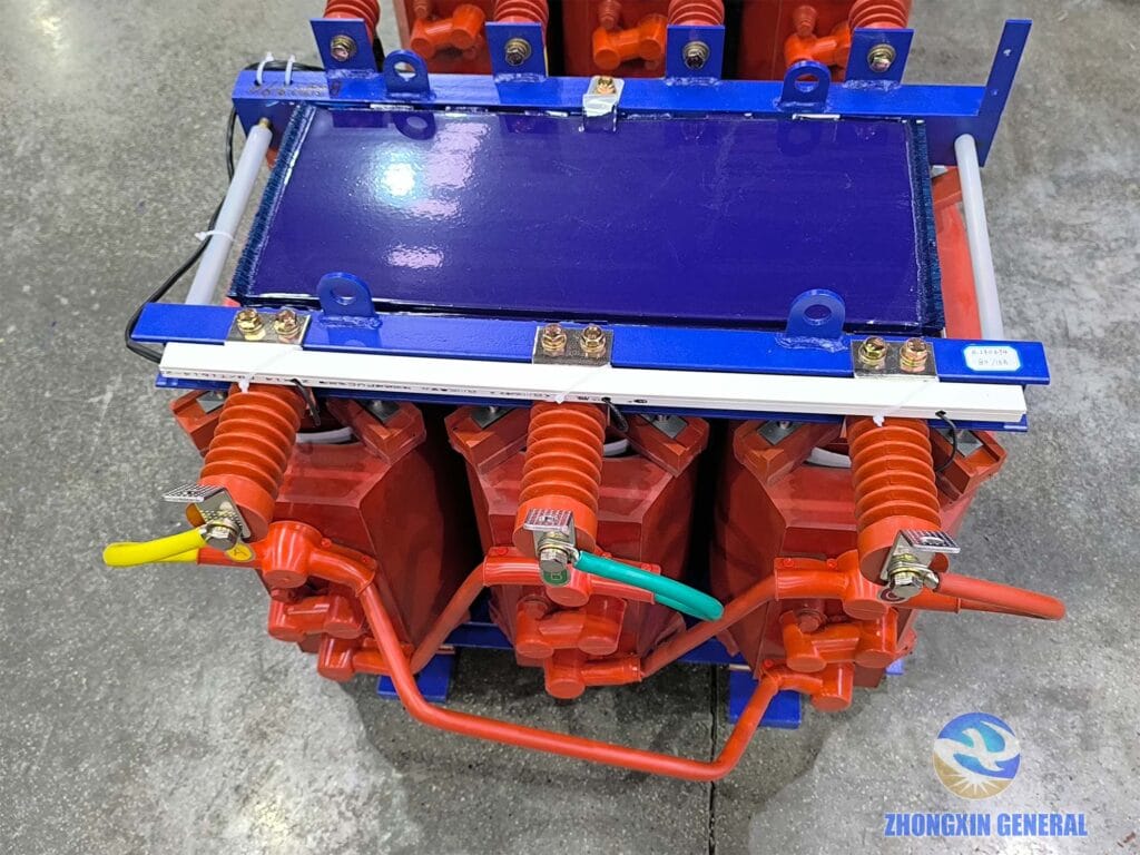 Three-phase cast resin dry-type transformer high-voltage terminal end close-up — HV bushing and tap connection detail Zhongxin General