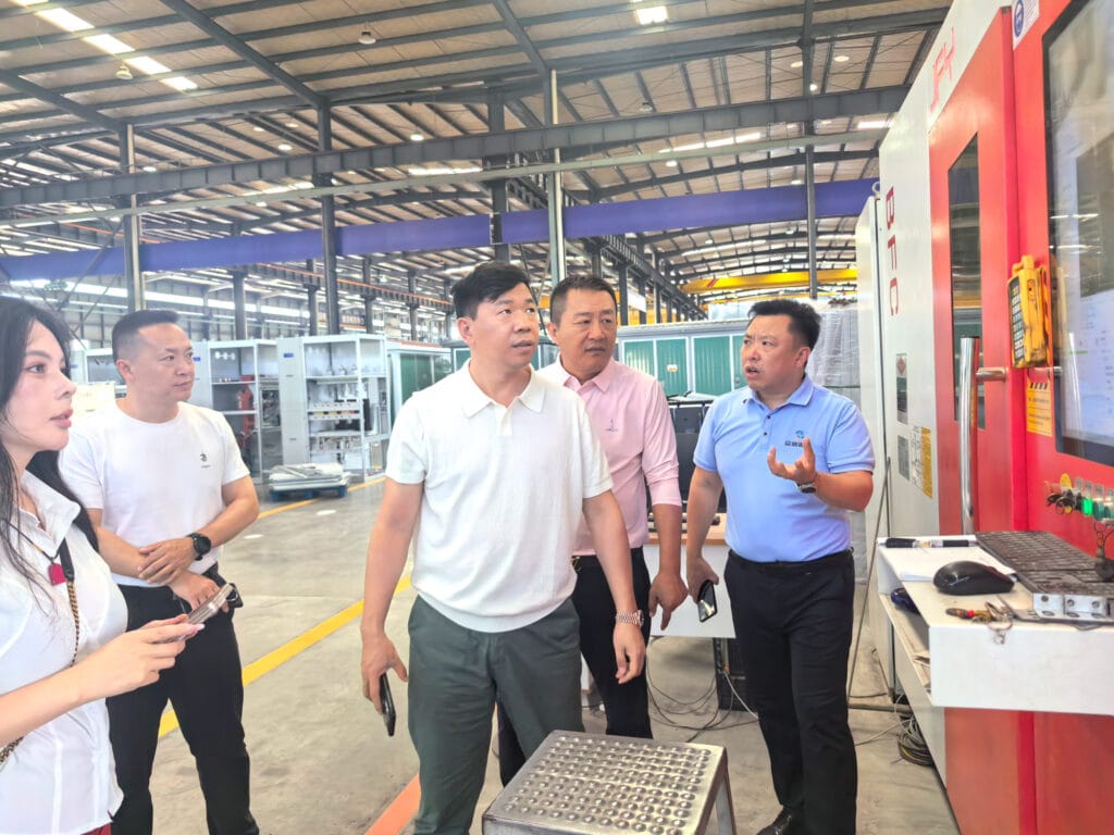 Zhongxin General General Manager Zhang Shaokuan introducing laser cutting equipment to visiting African diaspora delegation — factory tour Chengdu