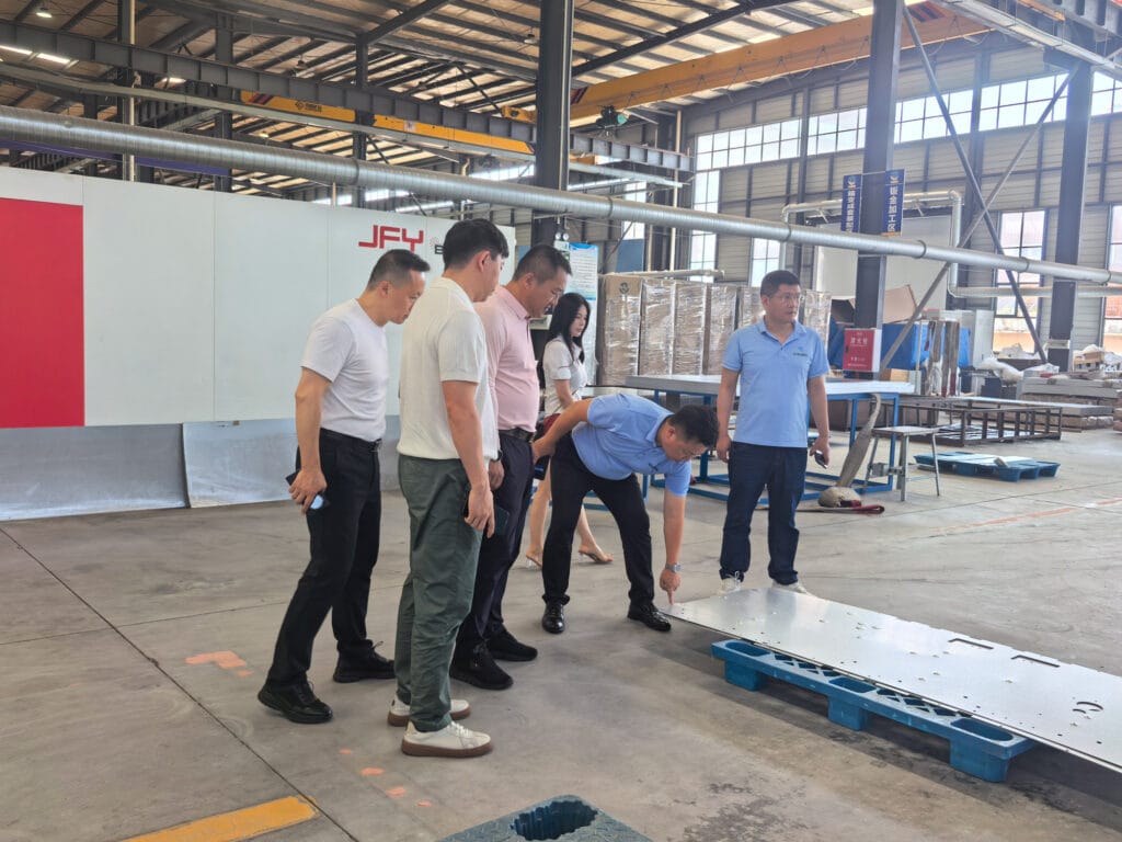 Zhongxin General General Manager Zhang Shaokuan explaining switchgear enclosure production process to visiting delegation — Sichuan factory