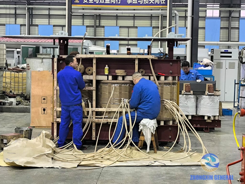 Technicians processing winding lead wires on a 10000kVA oil-immersed transformer