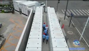 Aerial view of the Chengdu Xinjin Fangxin 10MW/h user-side battery storage project with technician inspecting the battery container aisle