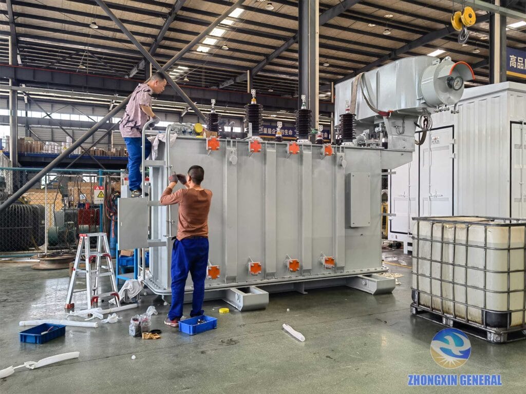 Two technicians performing installation work on 16000 kVA oil-immersed transformer — Zhongxin General factory