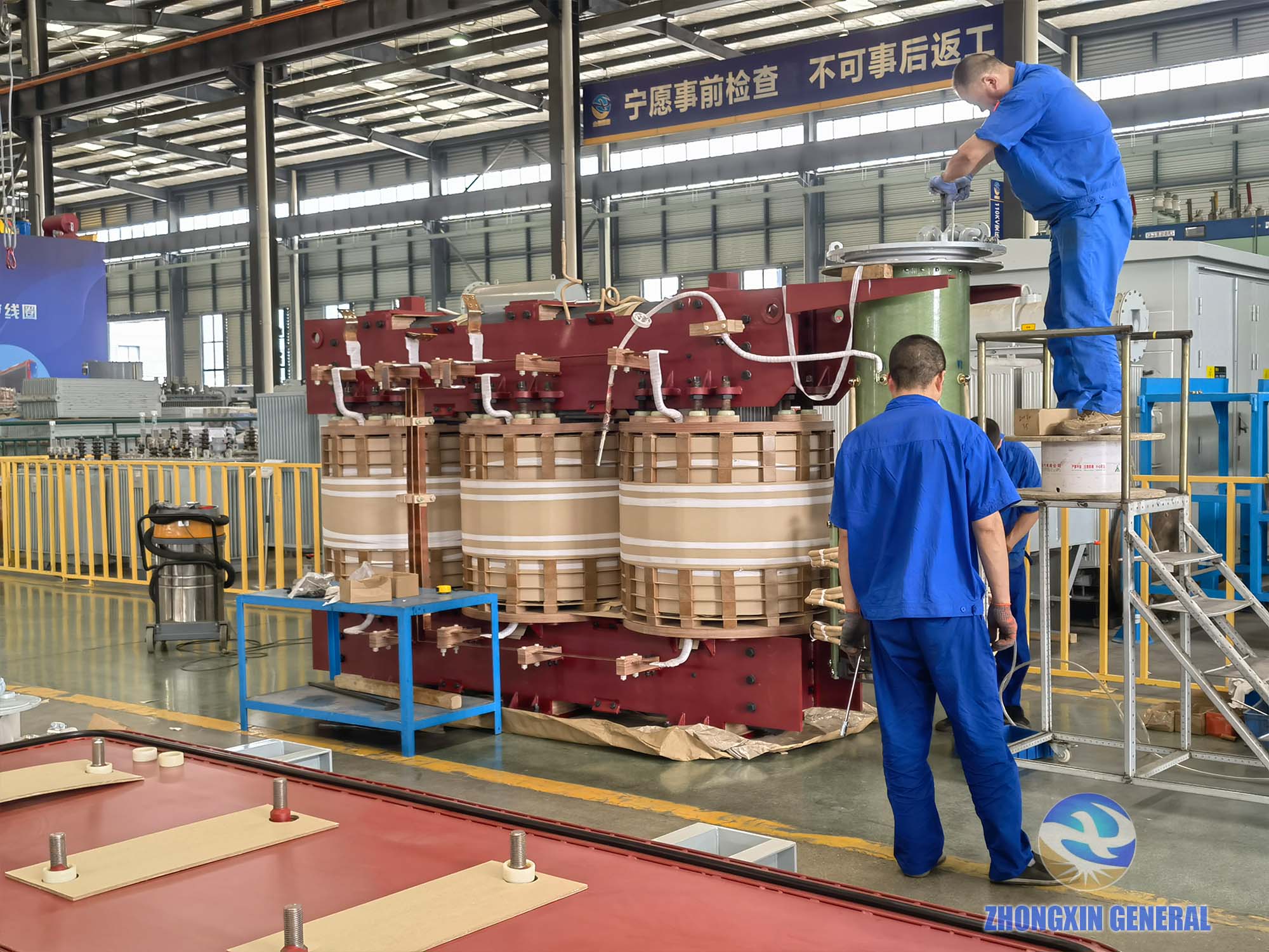 Technician installing on-load tap changer assembly on top of 31500kVA transformer — Zhongxin General
