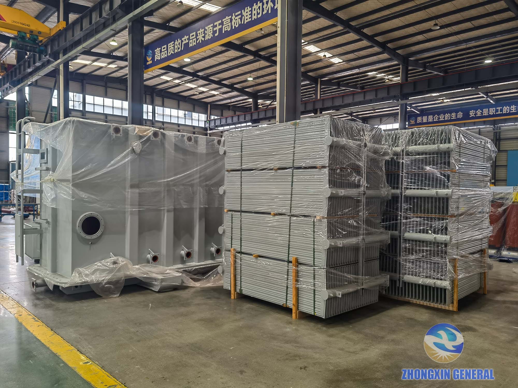 Radiator fins and white transformer tank shells staged for 31500kVA transformer assembly — Zhongxin General workshop