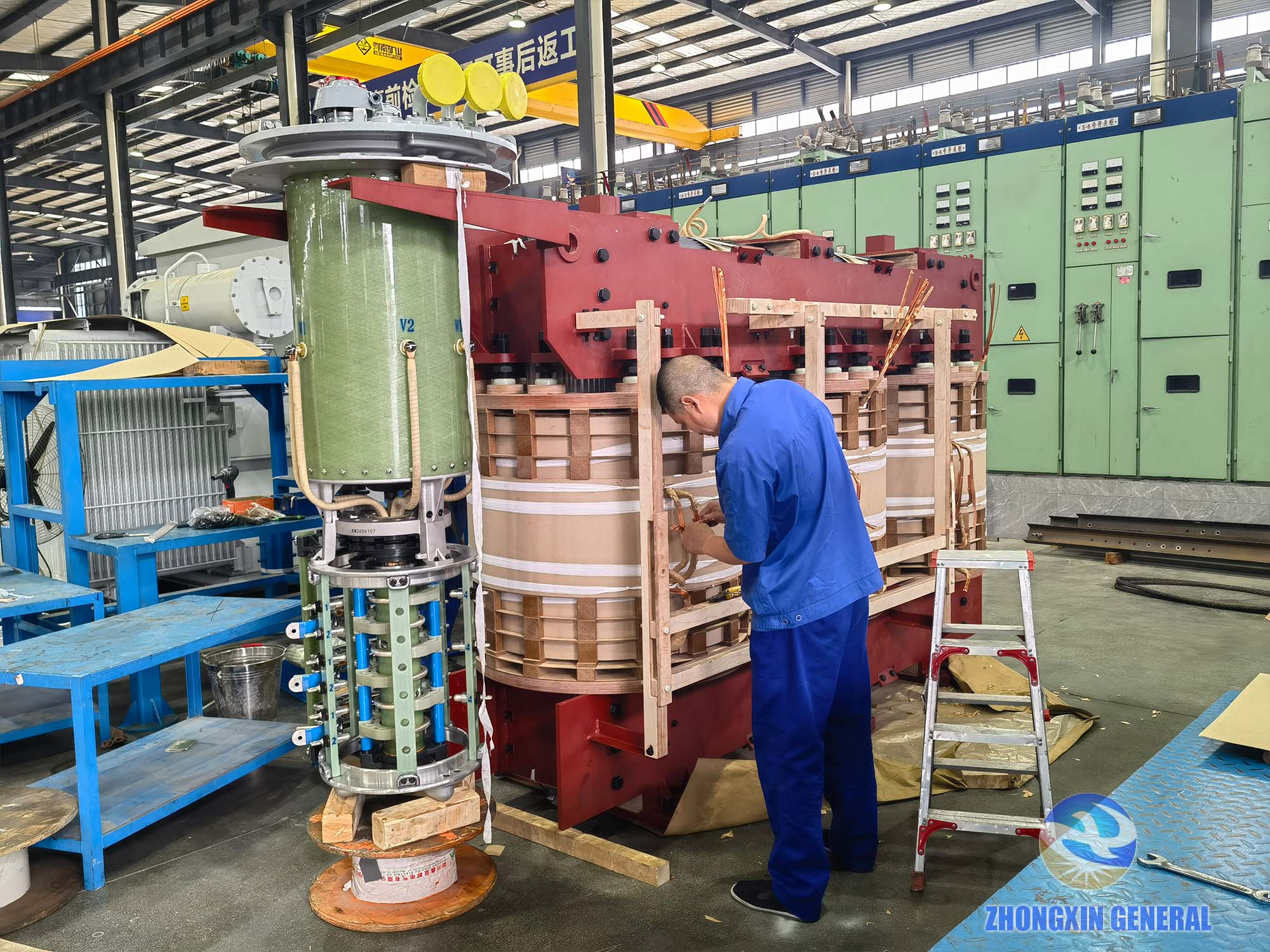 Technician connecting copper busbar to tap changer on 31500kVA transformer winding — Zhongxin General