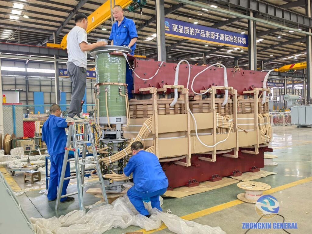 Technicians installing the on-load tap changer on a 63000kVA 110kV oil-immersed transformer — Zhongxin General