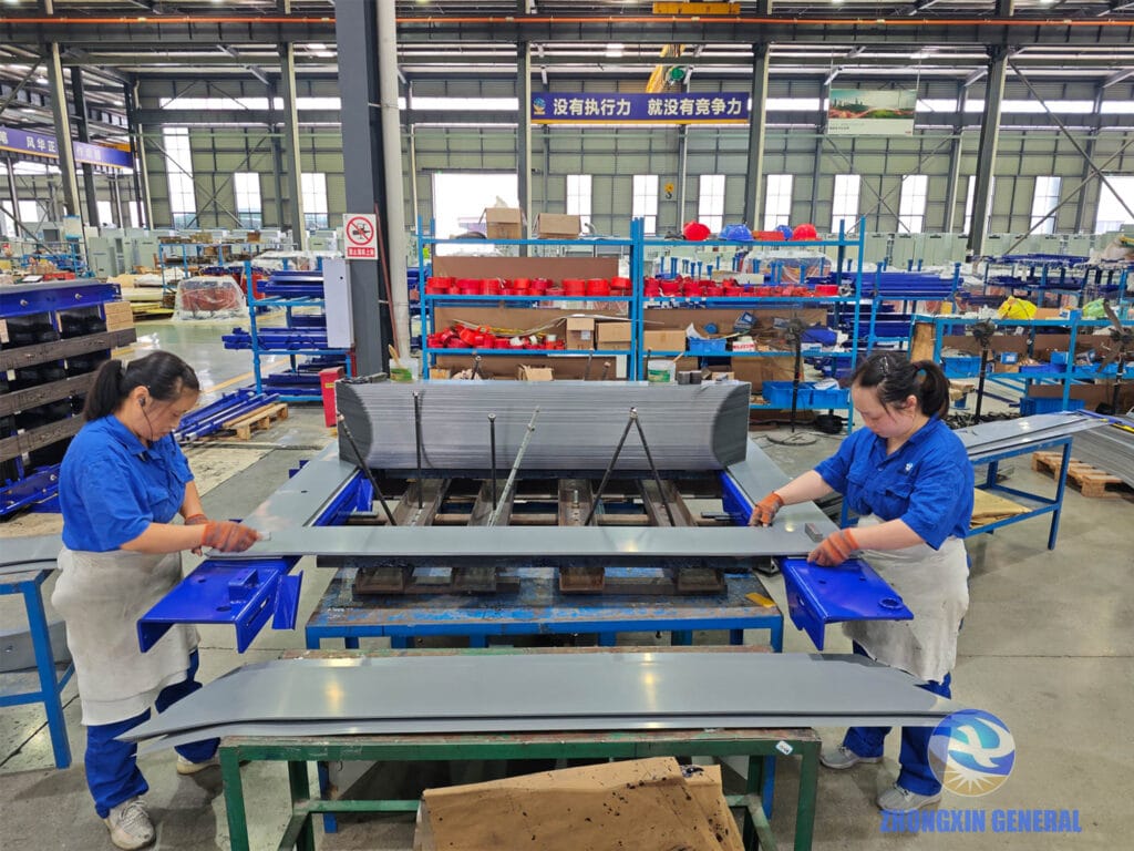 Technicians stacking silicon steel laminations for 8000kVA transformer core