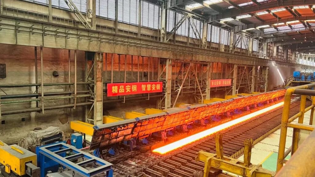 Glowing red steel billet traveling down the hot rolling line at Anyang Iron and Steel
