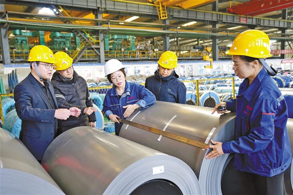 Worker measuring a finished grain-oriented silicon steel coil at Baotou Weifeng New Material