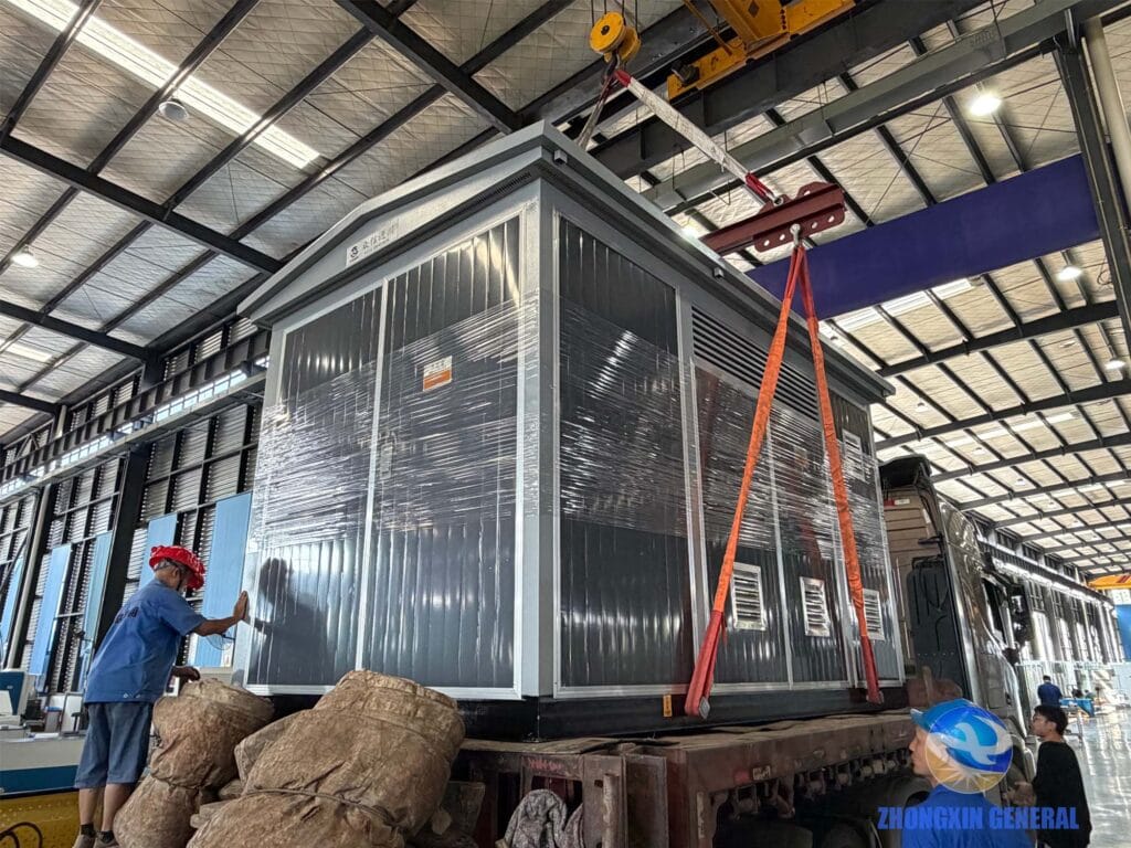 Crane lifting box-type substation onto delivery truck