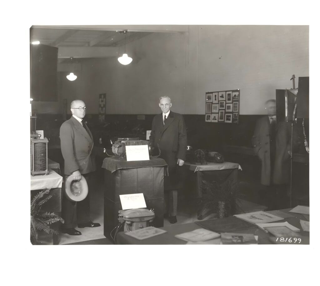F.A. Merrick and Henry Ford with an early transformer at the Ford Museum