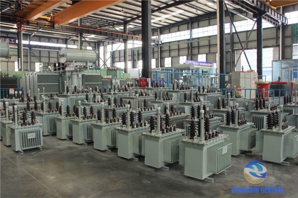 Finished oil-immersed transformers with conservator tanks in factory yard
