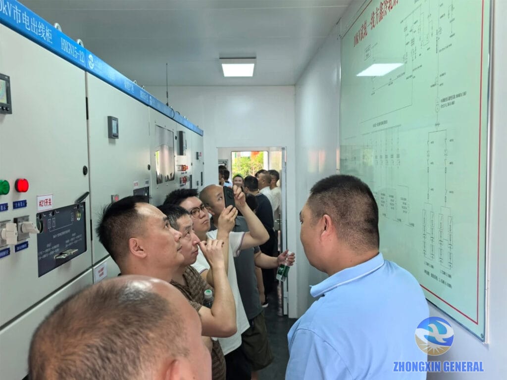 Project operations lead explaining the full storage system to visiting industry delegates