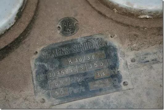 Century-old transformer nameplate showing Siemens characters