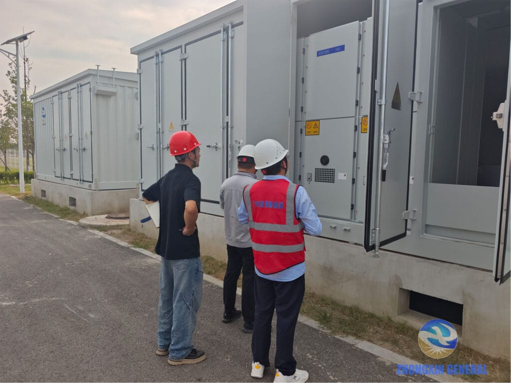 Technicians inspecting cabinet installation inside the prefabricated module — Zhongxin General