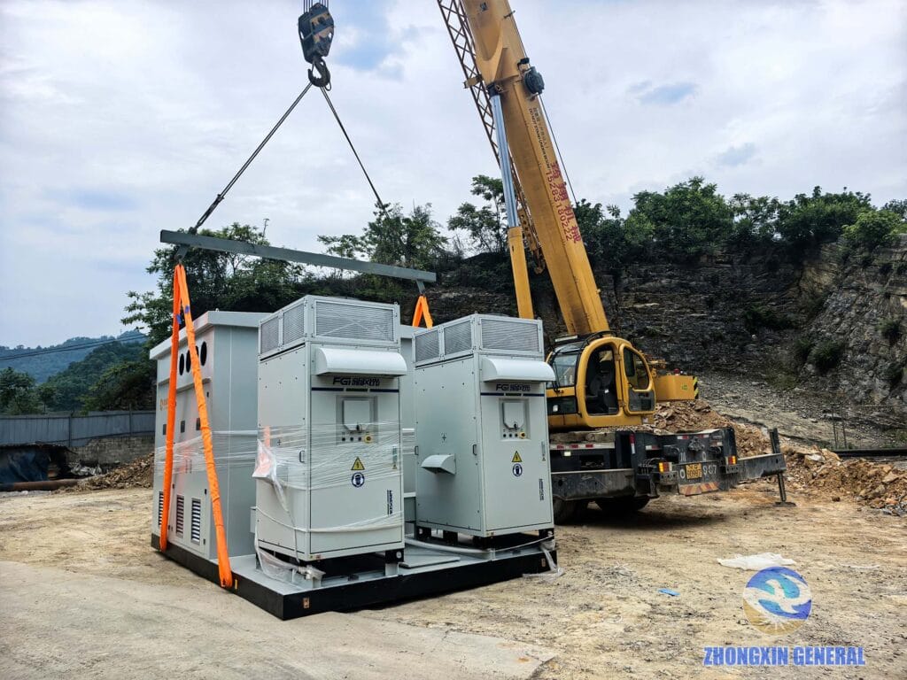 Crane lifting the step-up transformer cabin and inverters into position