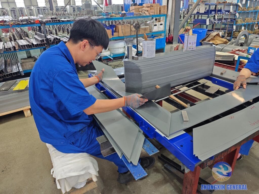 Workers laminate silicon steel to assemble transformer core body