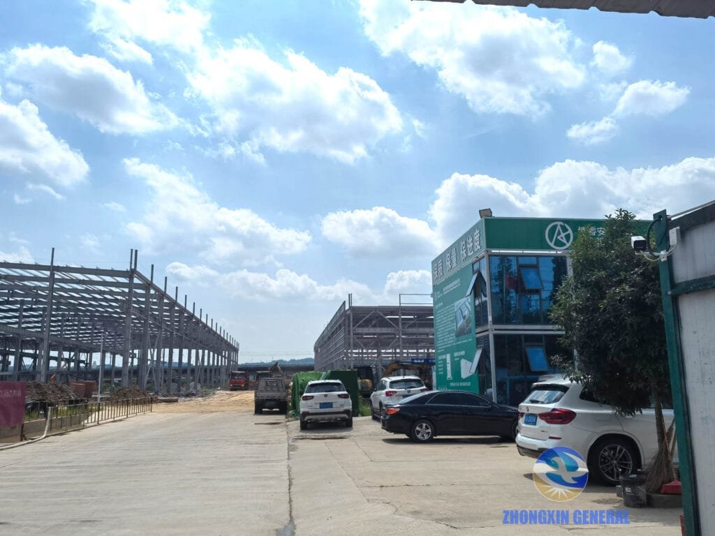Boruian New Energy storage manufacturing base construction site in Xinjin Chengdu, view from the central axis showing both workshop buildings under construction, June 29 2026