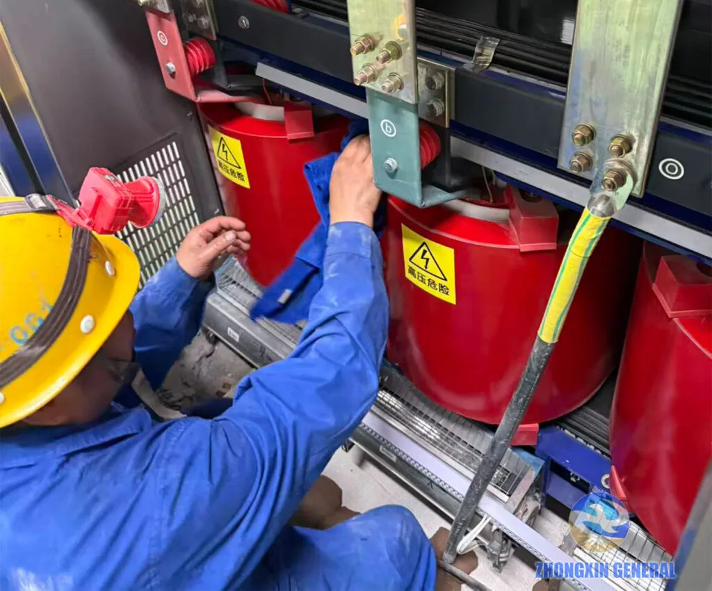 technician performing on‑site cleaning and maintenance work on dry‑type transformer winding