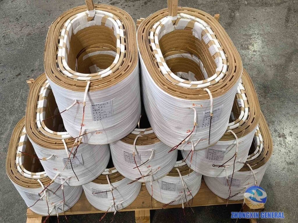Formed transformer windings stacked on wooden pallets