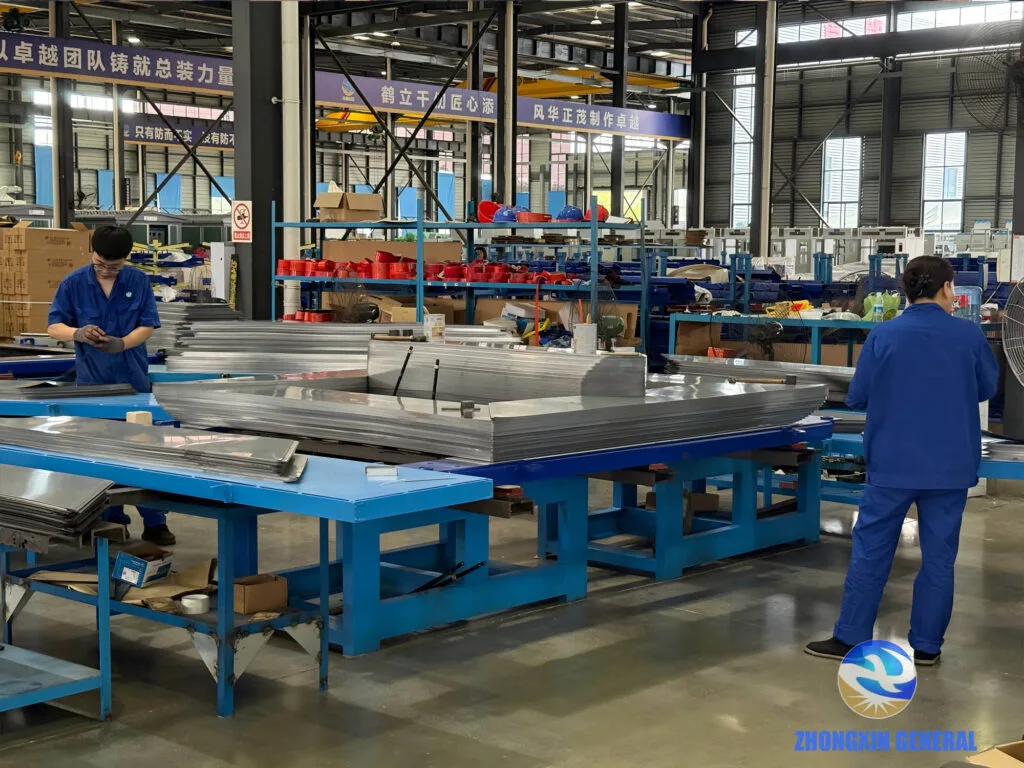 Workers pre-assembling silicon steel sheets for the transformer core