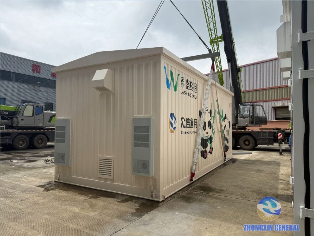 Crane beam positioned above the prefabricated cabin with lifting straps secured at its base
